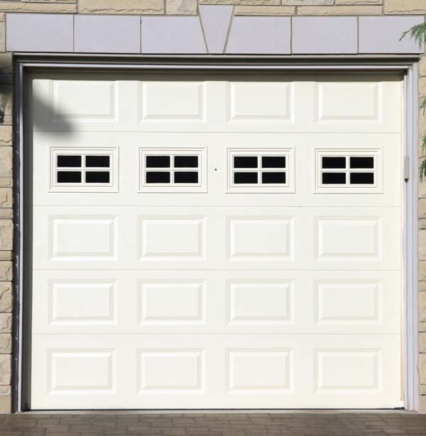 White garage door with 4 windows installed by Doors & More of the Treasure Coast