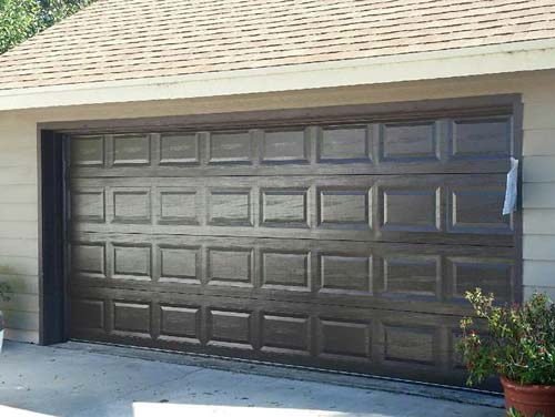 Dark brown garage door installed by Doors & More of the Treasure Coast in Fort Pierce, FL